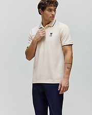 Mens Aram Pique Polo in cream, classic fit, with navy trim on the ribbed collar and cuffs, featuring a small embroidered Psycho Bunny skull logo on the left chest. (1)