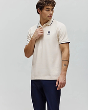 Mens Aram Pique Polo in cream, classic fit, with navy trim on the ribbed collar and cuffs, featuring a small embroidered Psycho Bunny skull logo on the left chest. (1)