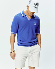Mens Innis Polo, a royal blue classic fit pique knit polo with a V-neck, white striped collar, white striped sleeve cuffs, and a small embroidered white Psycho Bunny skull logo on the left chest. (3)