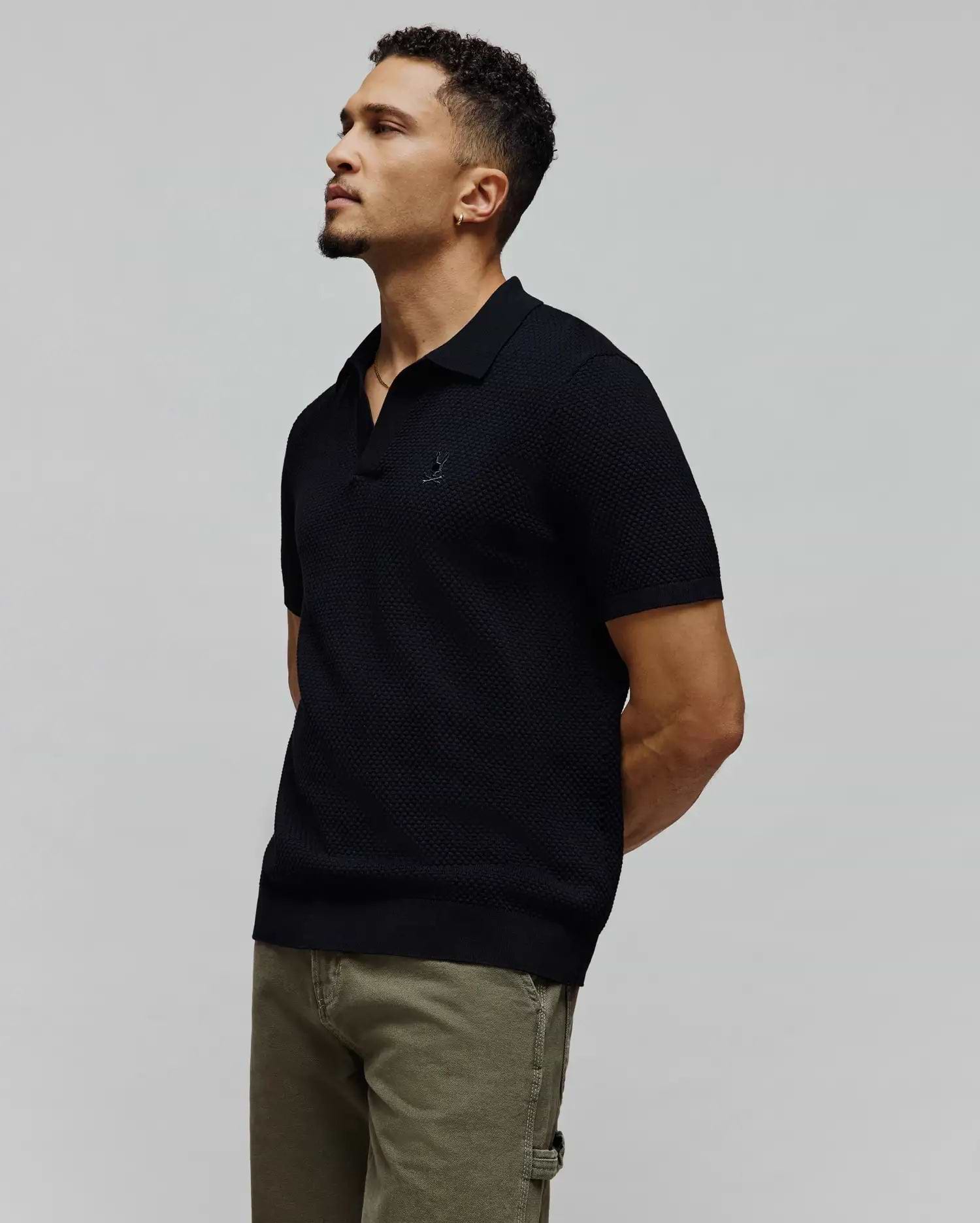 Black MENS DEVON KNIT POLO featuring a refined textured knit, classic fit, and the signature small embroidered Psycho Bunny skull logo prominently placed on the left chest.