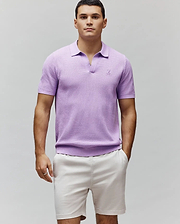 Mens Devon Knit Polo in lavender, featuring a textured knit fabric, classic fit, ribbed collar, cuffs, and hem, with a small embroidered Psycho Bunny skull logo on the left chest. (1)