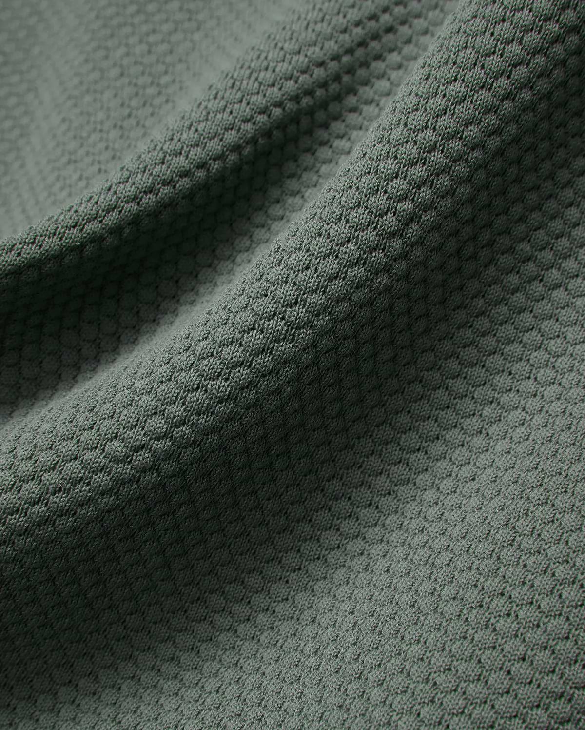 MENS DEVON KNIT POLO in a sophisticated dark sage green, highlighting its premium, soft-touch textured knit fabric with a subtle, refined micro-pattern for elevated style.