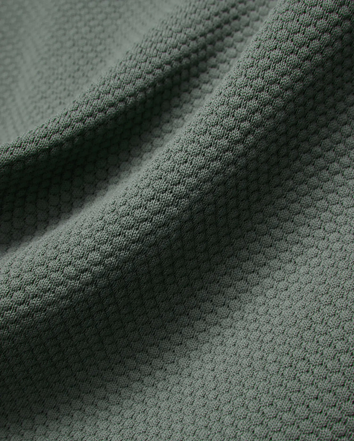MENS DEVON KNIT POLO in a sophisticated dark sage green, highlighting its premium, soft-touch textured knit fabric with a subtle, refined micro-pattern for elevated style.