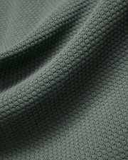 MENS DEVON KNIT POLO in a sophisticated dark sage green, highlighting its premium, soft-touch textured knit fabric with a subtle, refined micro-pattern for elevated style.