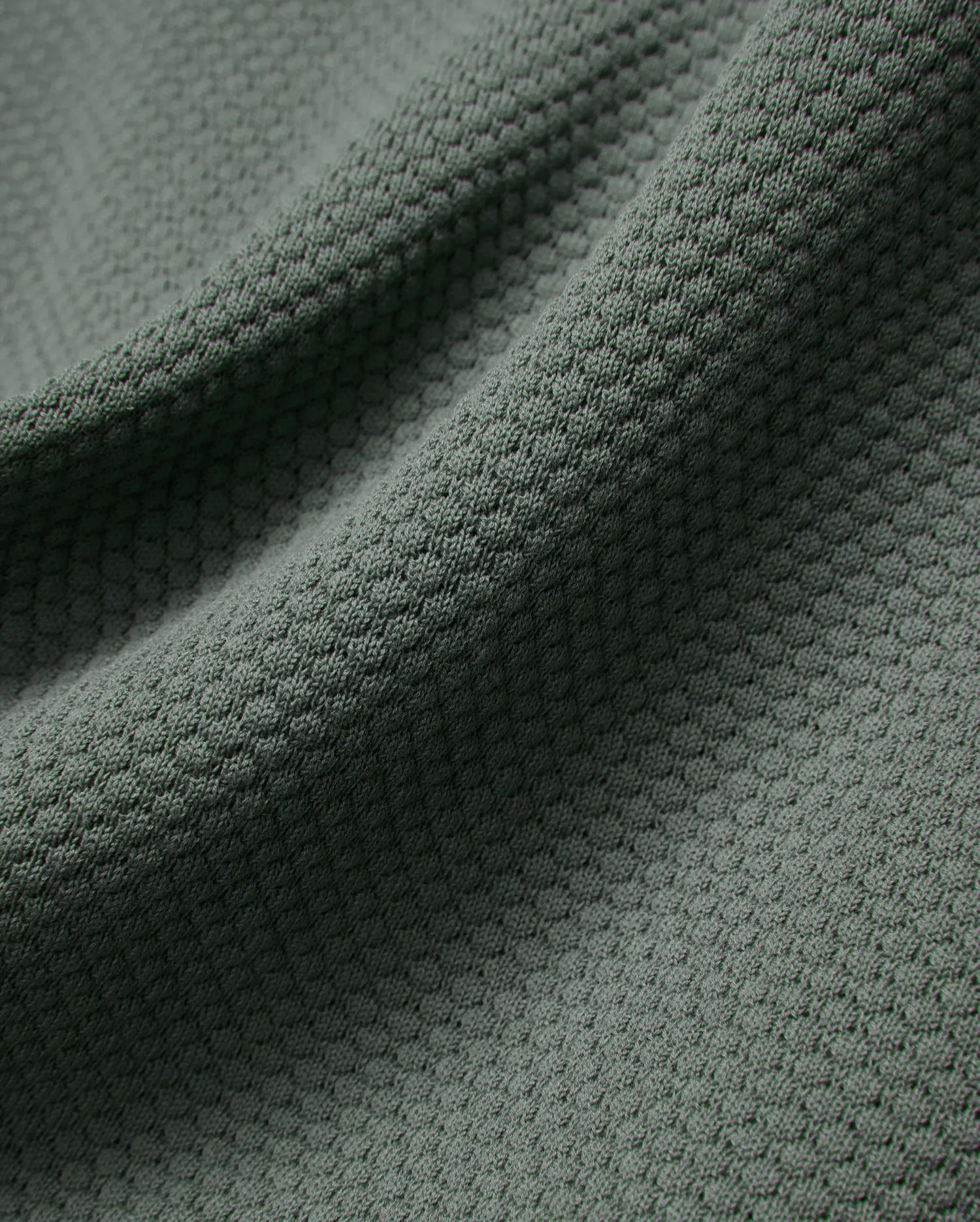MENS DEVON KNIT POLO in a sophisticated dark sage green, highlighting its premium, soft-touch textured knit fabric with a subtle, refined micro-pattern for elevated style.