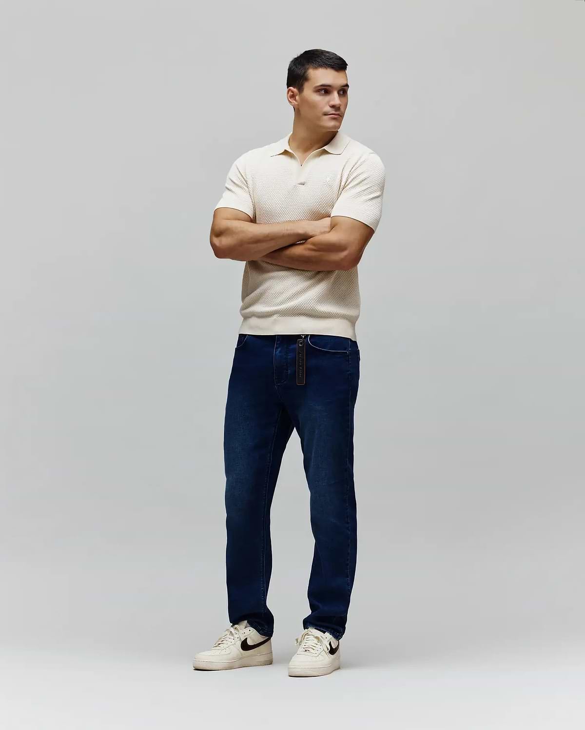 Mens Devon Knit Polo in cream, featuring a textured knit fabric, classic fit, and a small embroidered white Psycho Bunny skull logo on the left chest.