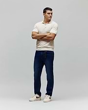 Mens Devon Knit Polo in cream, featuring a textured knit fabric, classic fit, and a small embroidered white Psycho Bunny skull logo on the left chest.