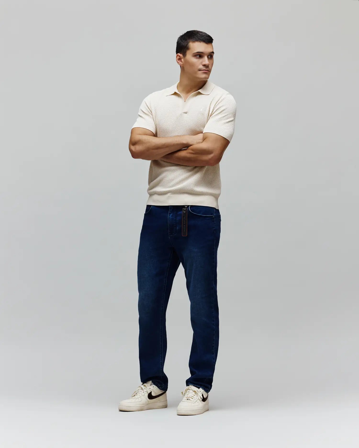 Mens Devon Knit Polo in cream, featuring a textured knit fabric, classic fit, and a small embroidered white Psycho Bunny skull logo on the left chest.