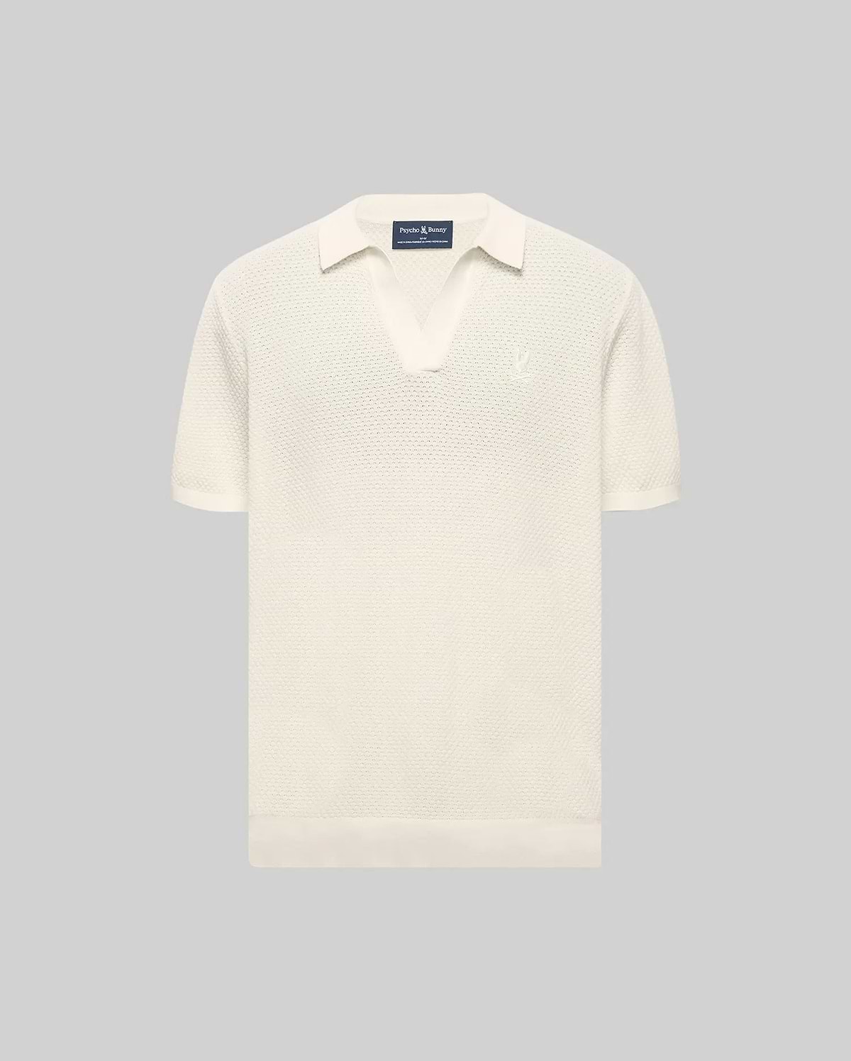 MENS DEVON KNIT POLO in cream, featuring a classic fit, textured knit fabric, open collar, ribbed cuffs and hem, and a small embroidered Psycho Bunny skull logo on the left chest.