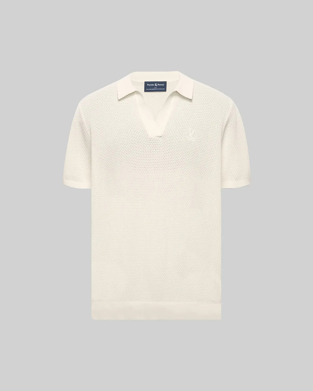 MENS DEVON KNIT POLO in cream, featuring a classic fit, textured knit fabric, open collar, ribbed cuffs and hem, and a small embroidered Psycho Bunny skull logo on the left chest.