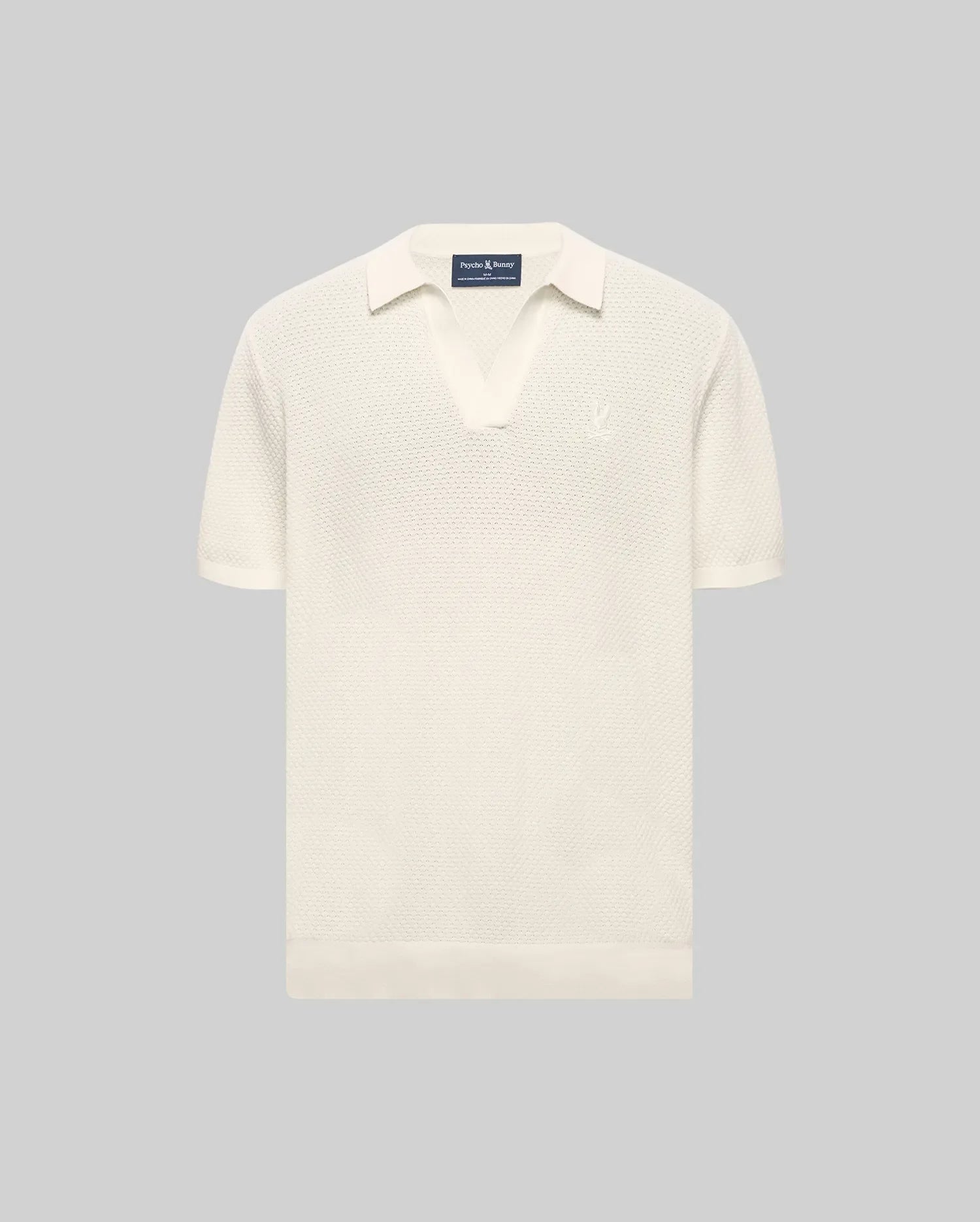 MENS DEVON KNIT POLO in cream, featuring a classic fit, textured knit fabric, open collar, ribbed cuffs and hem, and a small embroidered Psycho Bunny skull logo on the left chest.