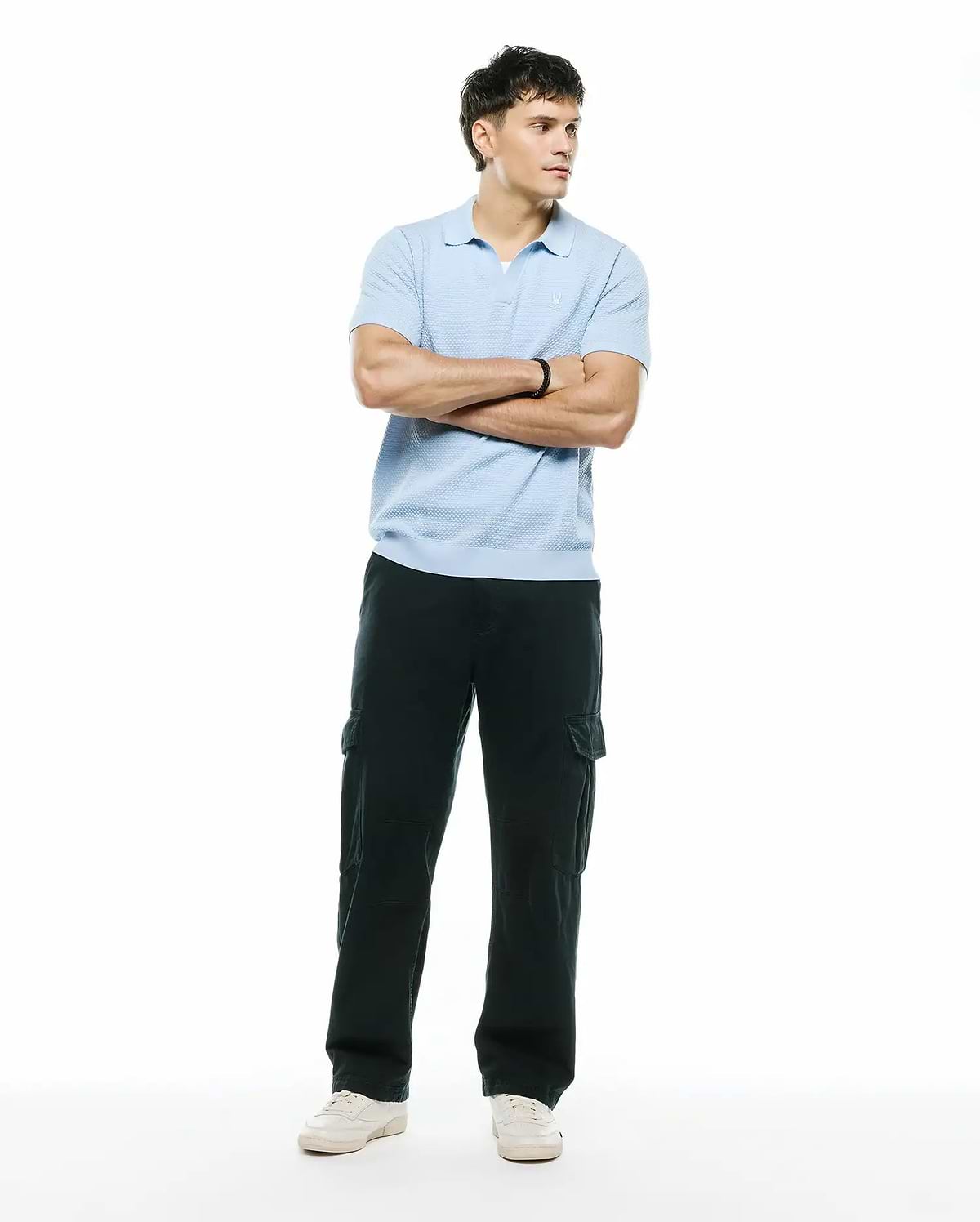 Mens Devon Bubble Stitch Knit Polo, a light blue classic fit polo featuring a textured bubble stitch knit fabric and a small embroidered Psycho Bunny skull logo on the left chest. (5)