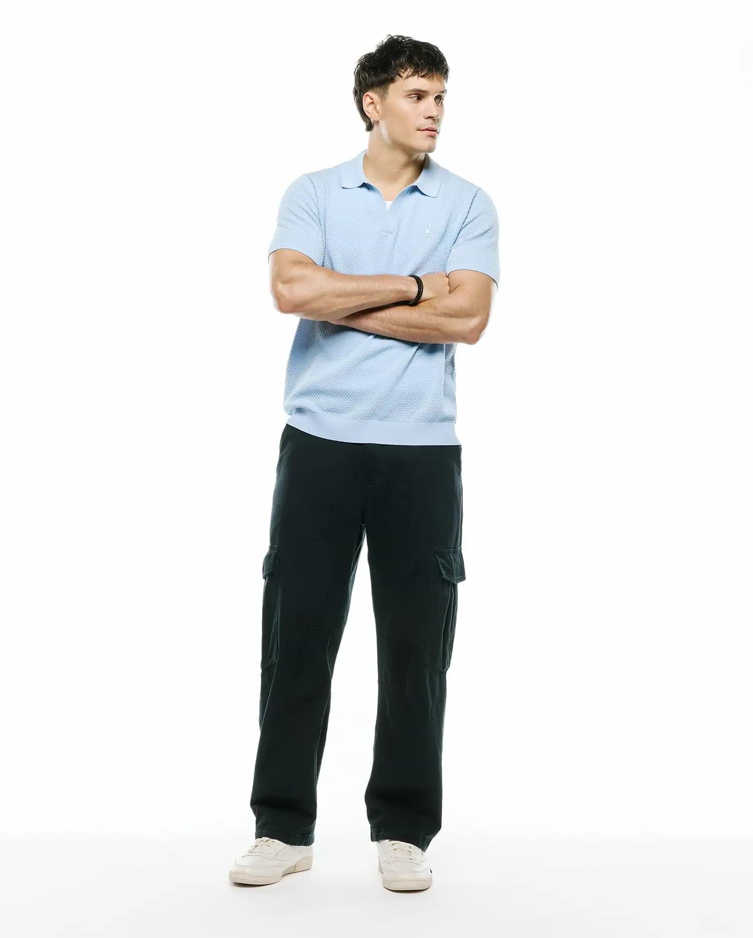 Mens Devon Bubble Stitch Knit Polo, a light blue classic fit polo featuring a textured bubble stitch knit fabric and a small embroidered Psycho Bunny skull logo on the left chest. (5)