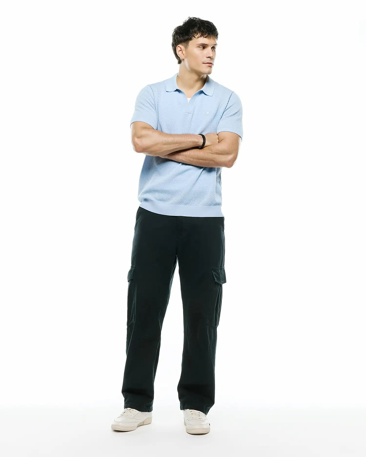 Mens Devon Bubble Stitch Knit Polo, a light blue classic fit polo featuring a textured bubble stitch knit fabric and a small embroidered Psycho Bunny skull logo on the left chest. (5)