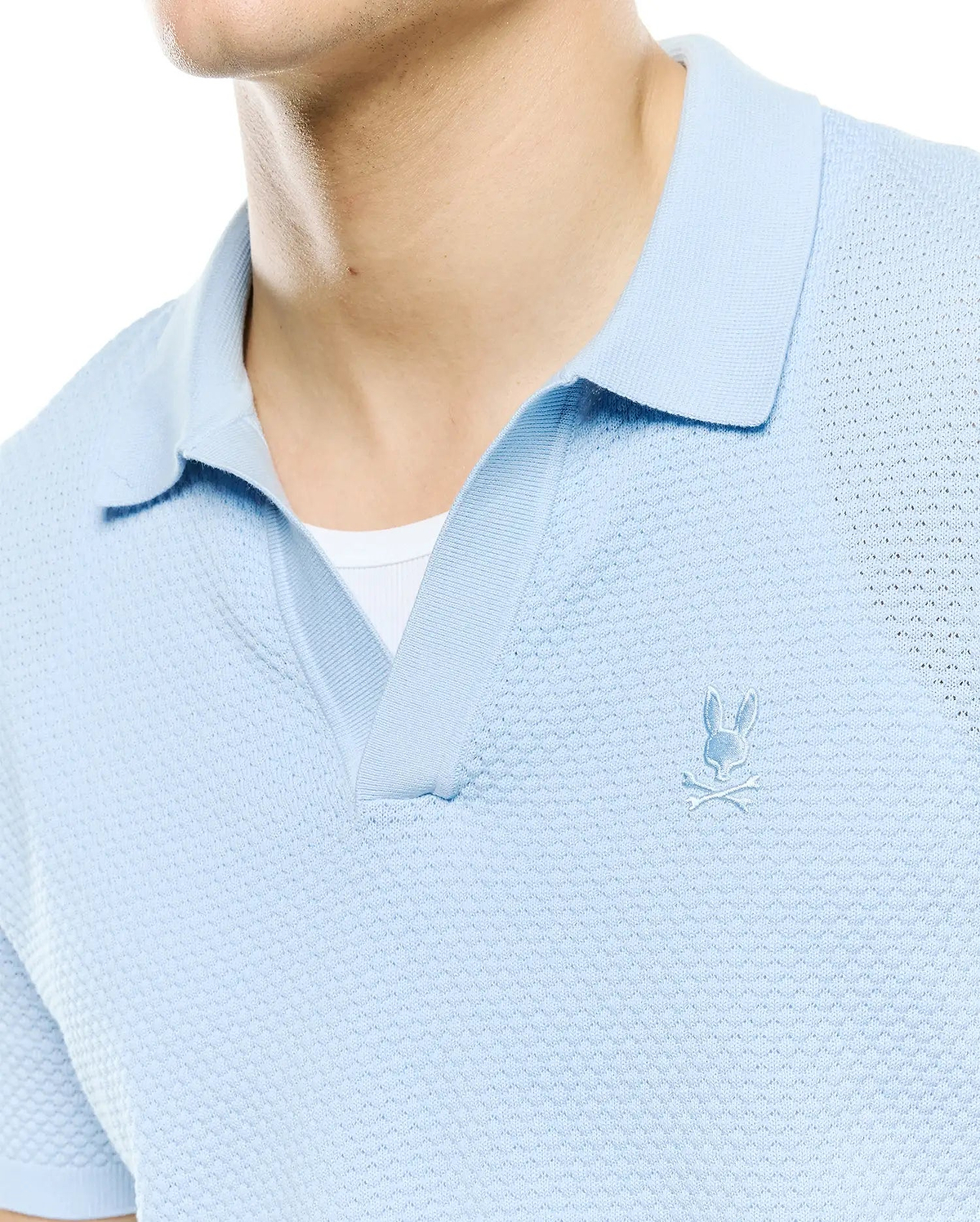 Mens Devon Bubble Stitch Knit Polo in light blue, featuring a unique bubble stitch texture, open placket, and a small, tonal embroidered Psycho Bunny skull logo on the left chest. (3)