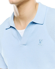 Mens Devon Bubble Stitch Knit Polo in light blue, featuring a unique bubble stitch texture, open placket, and a small, tonal embroidered Psycho Bunny skull logo on the left chest. (3)