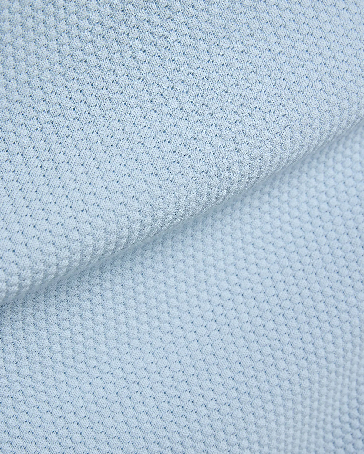 Light blue Mens Devon Bubble Stitch Knit Polo fabric, a premium menswear piece showcasing its unique, refined bubble stitch knit texture, perfect for sophisticated streetwear. (7)