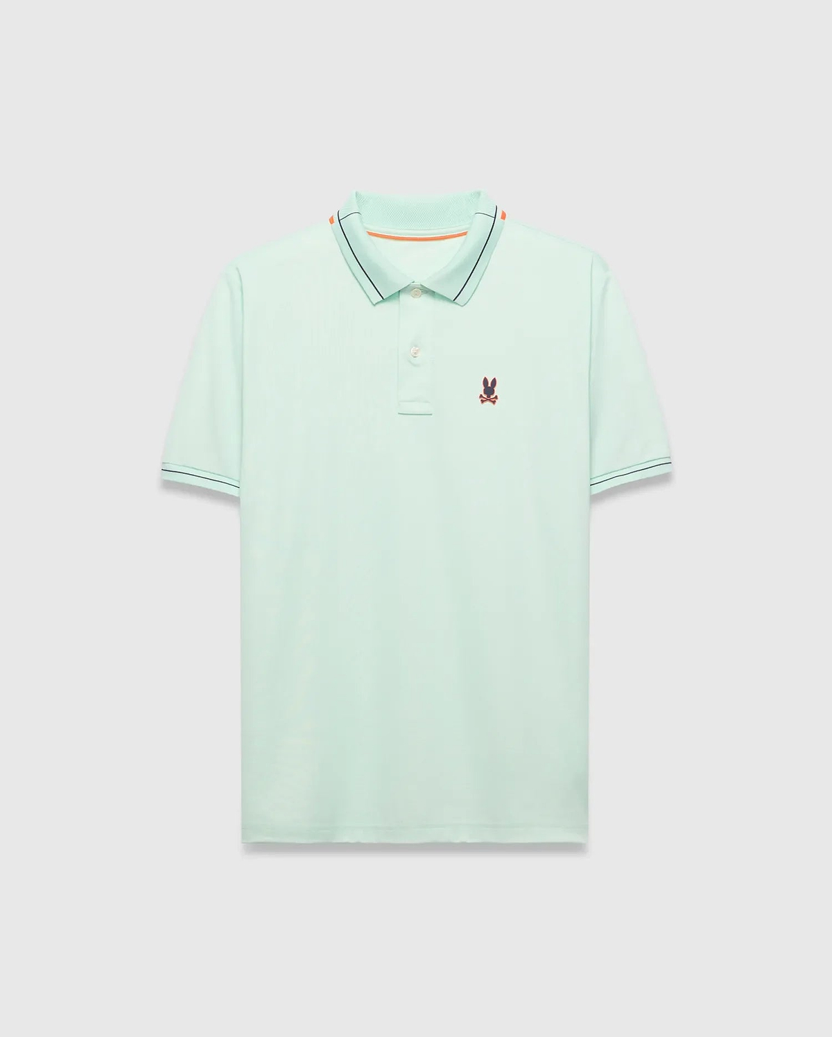 Mens Edwin Sport Polo, a classic fit light green pique polo with a black and orange striped collar, matching black striped cuffs, and a small embroidered Psycho Bunny skull logo on the left chest.