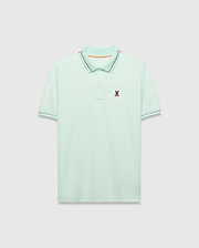 Mens Edwin Sport Polo, a classic fit light green pique polo with a black and orange striped collar, matching black striped cuffs, and a small embroidered Psycho Bunny skull logo on the left chest.