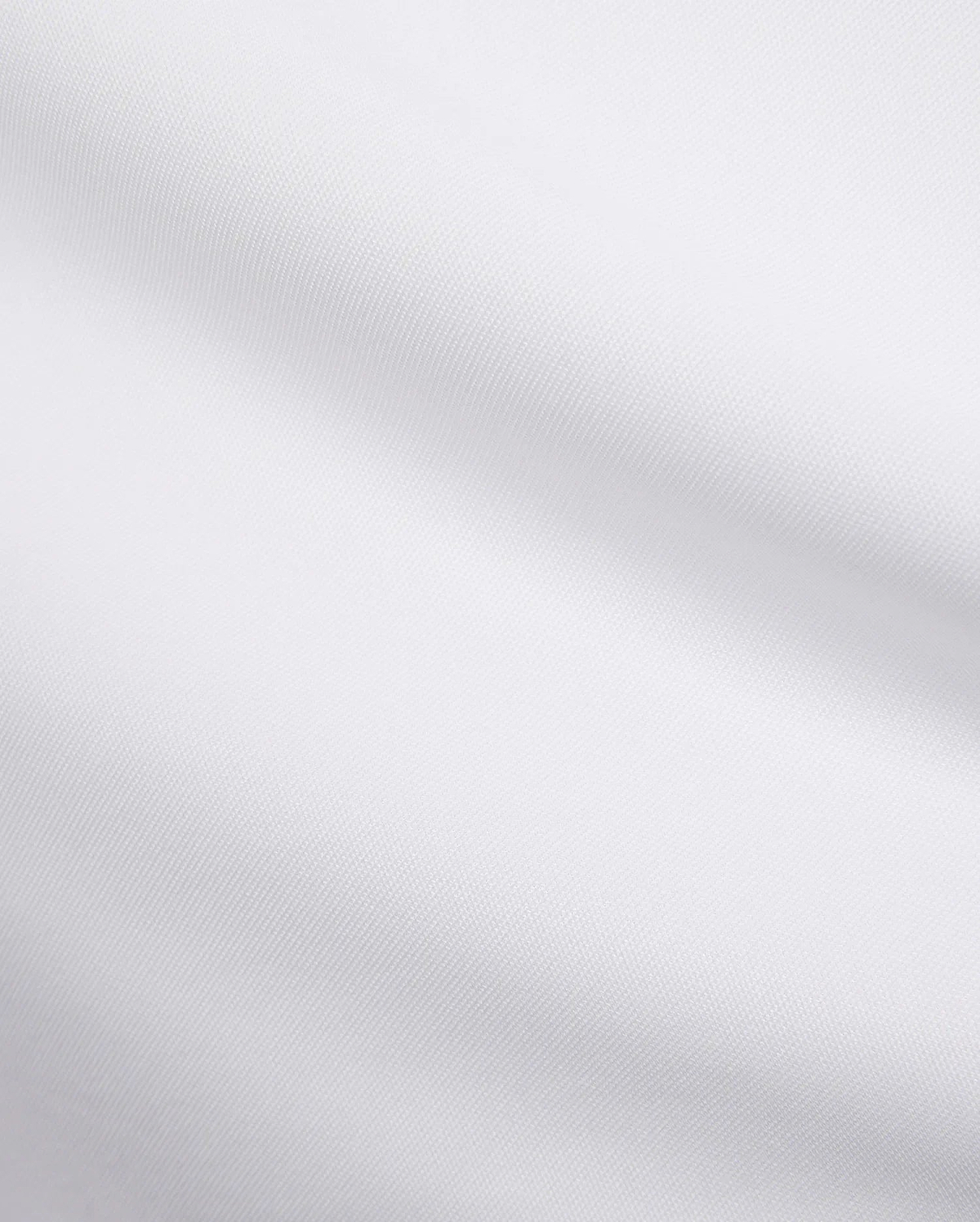 Mens Edwin Sport Polo, a premium white pique fabric, showcasing its refined textured weave. This high-quality material is characteristic of Psycho Bunny's sophisticated streetwear.