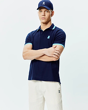 Mens Holden Pique Polo in navy, featuring a classic fit, pique texture, light blue contrast tipping on the collar and cuffs, and a small embroidered light blue Psycho Bunny skull logo on the left chest. (1)