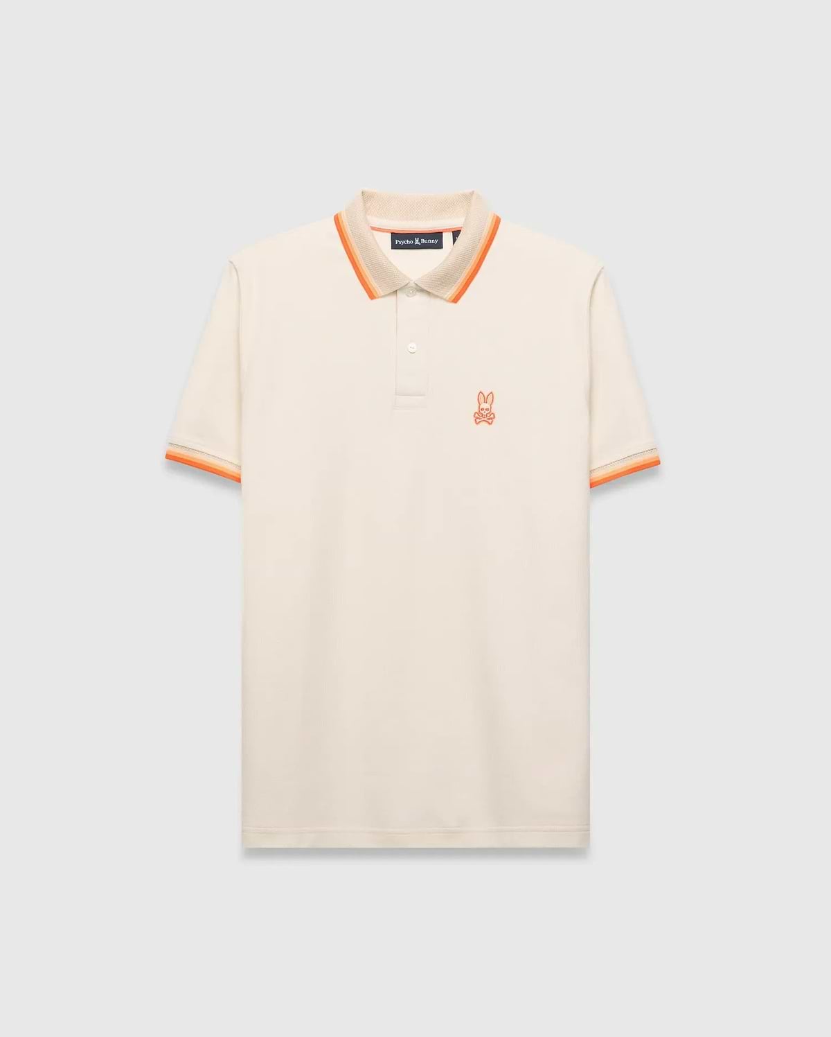 Mens Holden Pique Polo, a classic fit cream pique polo with orange and tan striped collar and cuffs, featuring a small embroidered orange Psycho Bunny skull logo on the left chest. (5)
