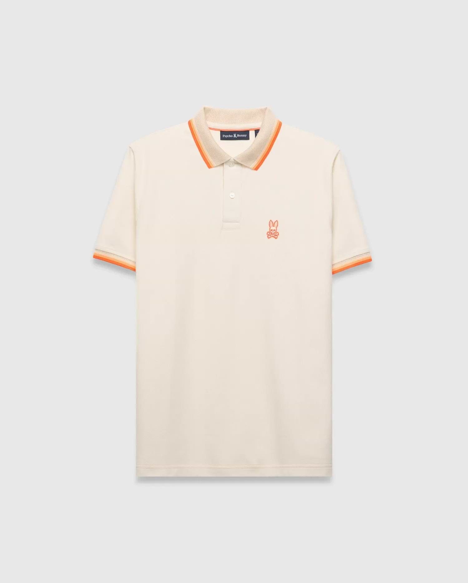 Mens Holden Pique Polo, a classic fit cream pique polo with orange and tan striped collar and cuffs, featuring a small embroidered orange Psycho Bunny skull logo on the left chest. (5)