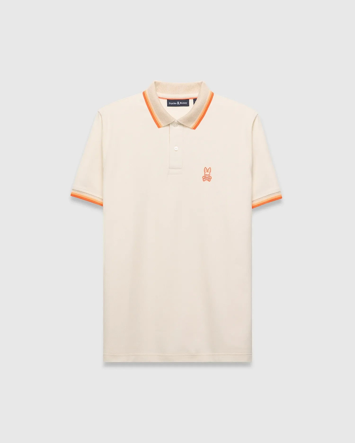 Mens Holden Pique Polo, a classic fit cream pique polo with orange and tan striped collar and cuffs, featuring a small embroidered orange Psycho Bunny skull logo on the left chest. (5)