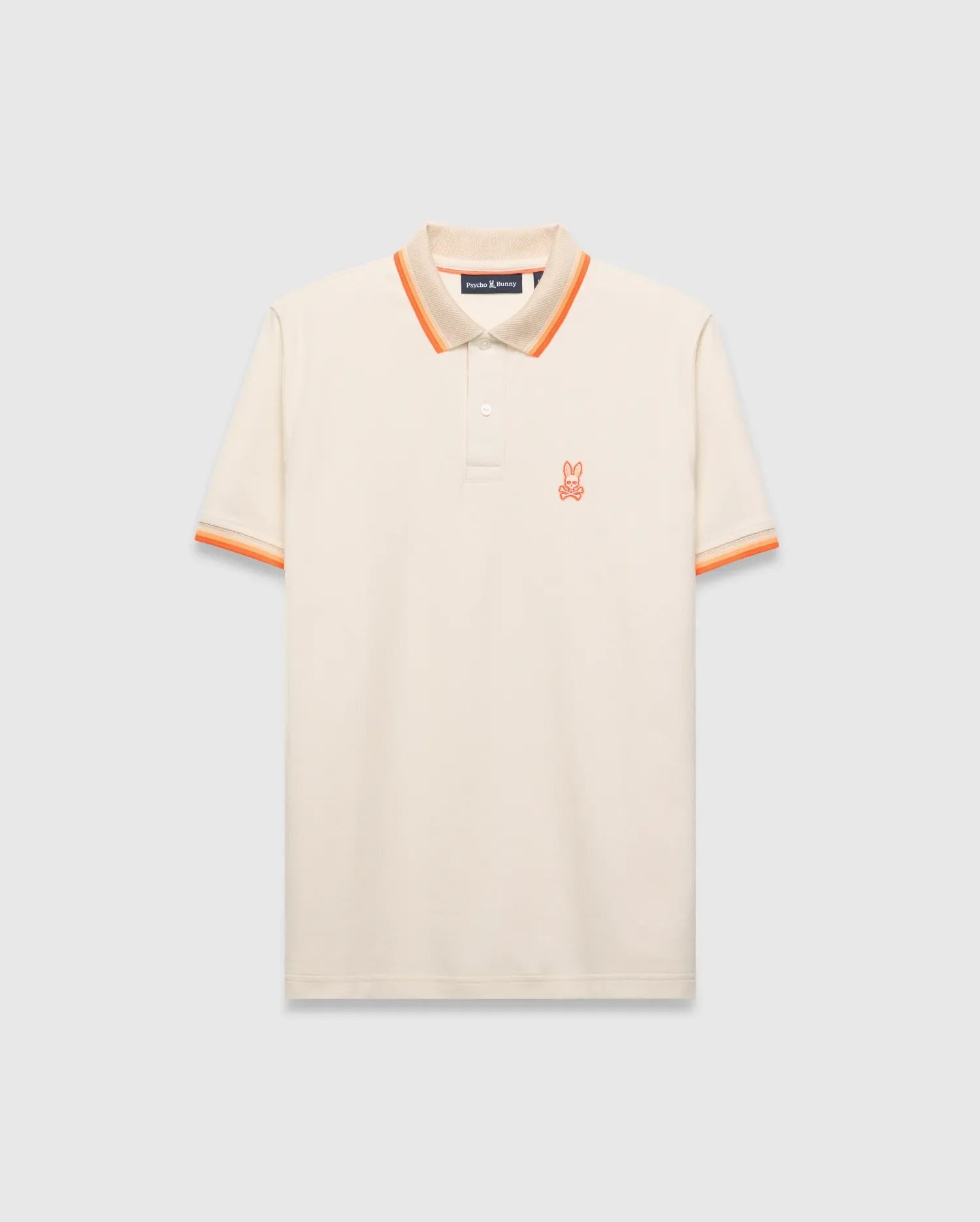 Mens Holden Pique Polo, a classic fit cream pique polo with orange and tan striped collar and cuffs, featuring a small embroidered orange Psycho Bunny skull logo on the left chest. (5)