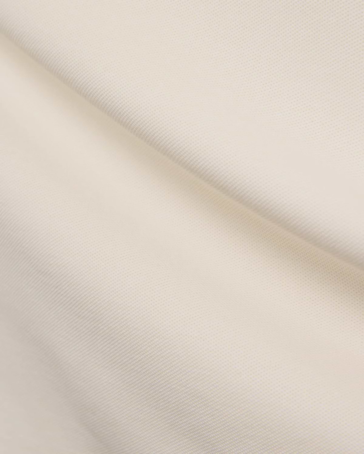 Mens Holden Pique Polo in a refined cream color, showcasing its classic textured pique fabric, typically featuring the signature embroidered Psycho Bunny skull logo on the chest for a classic fit. (6)