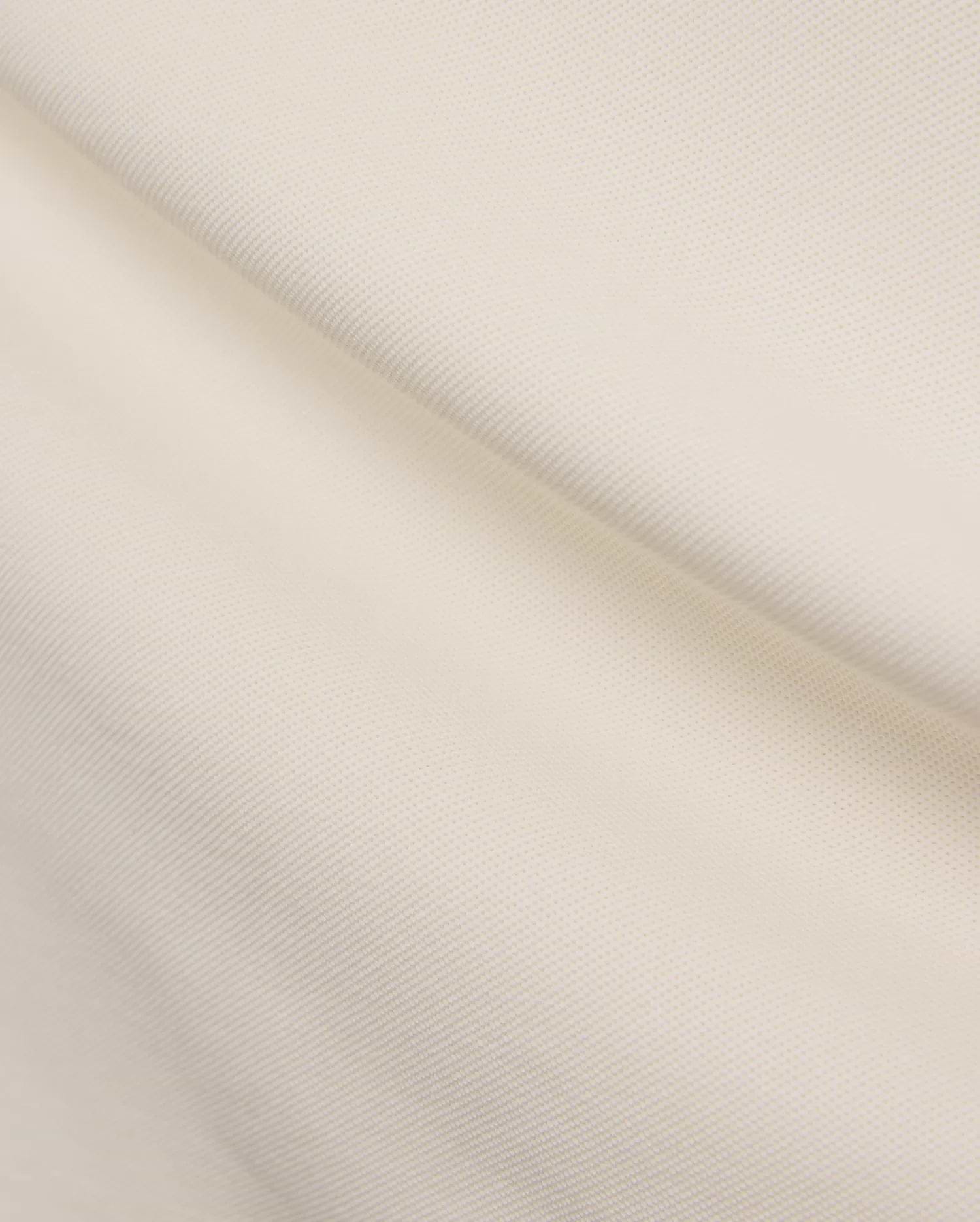 Mens Holden Pique Polo in a refined cream color, showcasing its classic textured pique fabric, typically featuring the signature embroidered Psycho Bunny skull logo on the chest for a classic fit. (6)