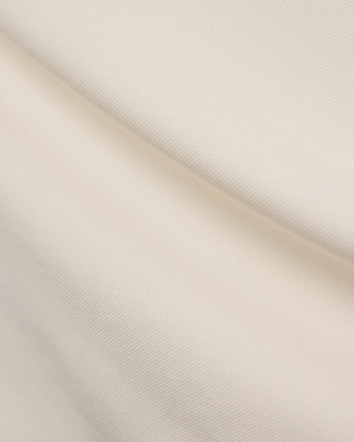 Mens Holden Pique Polo in a refined cream color, showcasing its classic textured pique fabric, typically featuring the signature embroidered Psycho Bunny skull logo on the chest for a classic fit. (6)