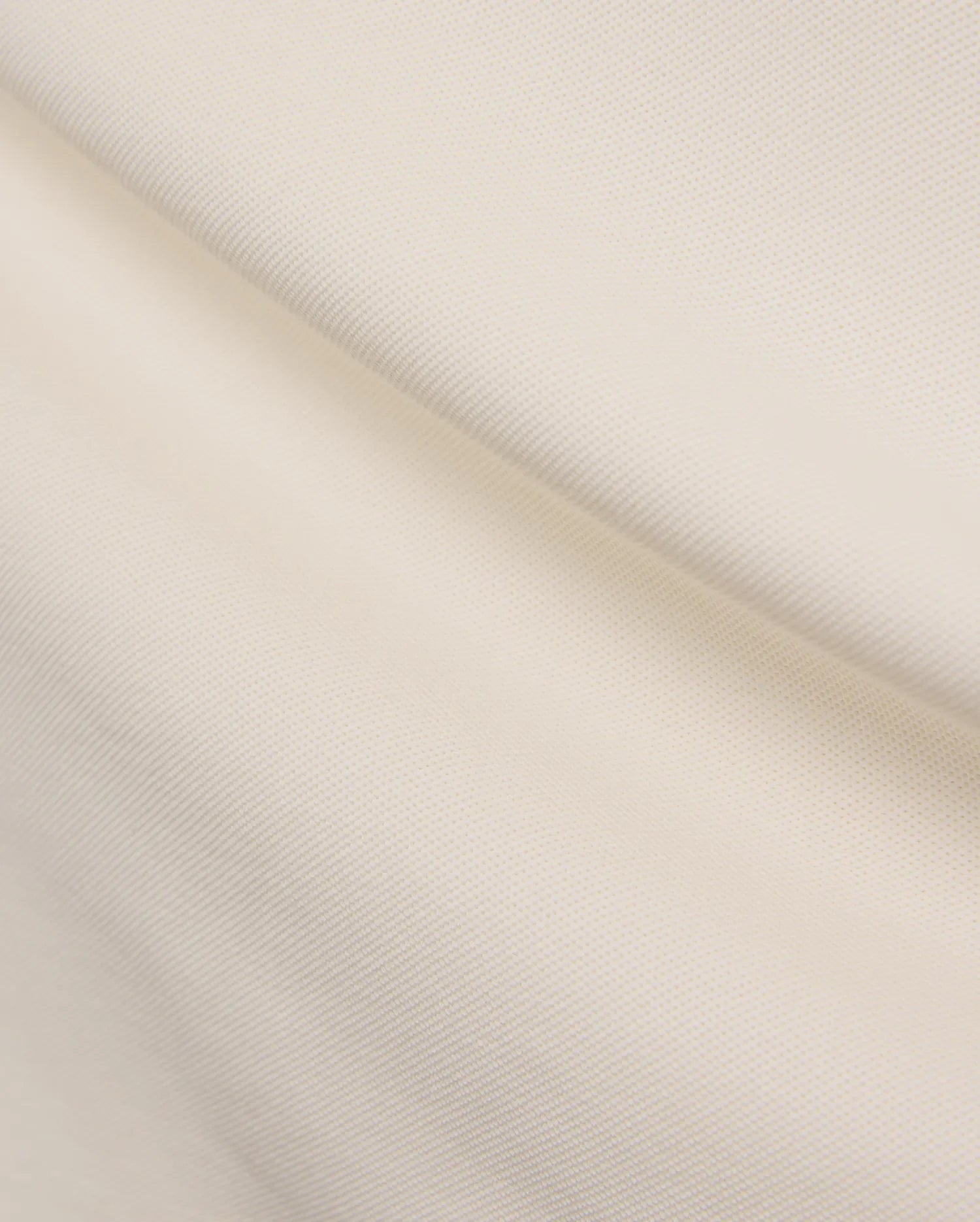 Mens Holden Pique Polo in a refined cream color, showcasing its classic textured pique fabric, typically featuring the signature embroidered Psycho Bunny skull logo on the chest for a classic fit. (6)