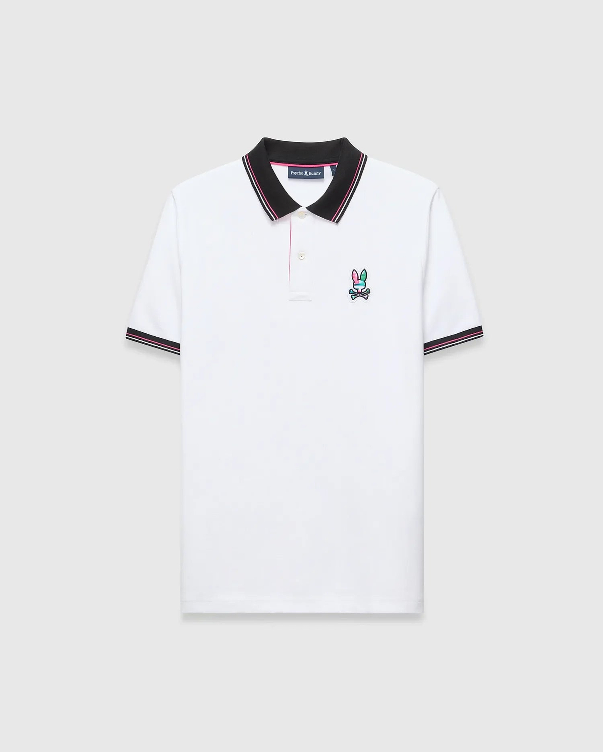 Mens Nate Pique Polo, classic fit, white pique fabric with a black ribbed collar and cuffs with pink/white stripes. A small, embroidered pink, teal, and black Psycho Bunny skull logo on the left chest.