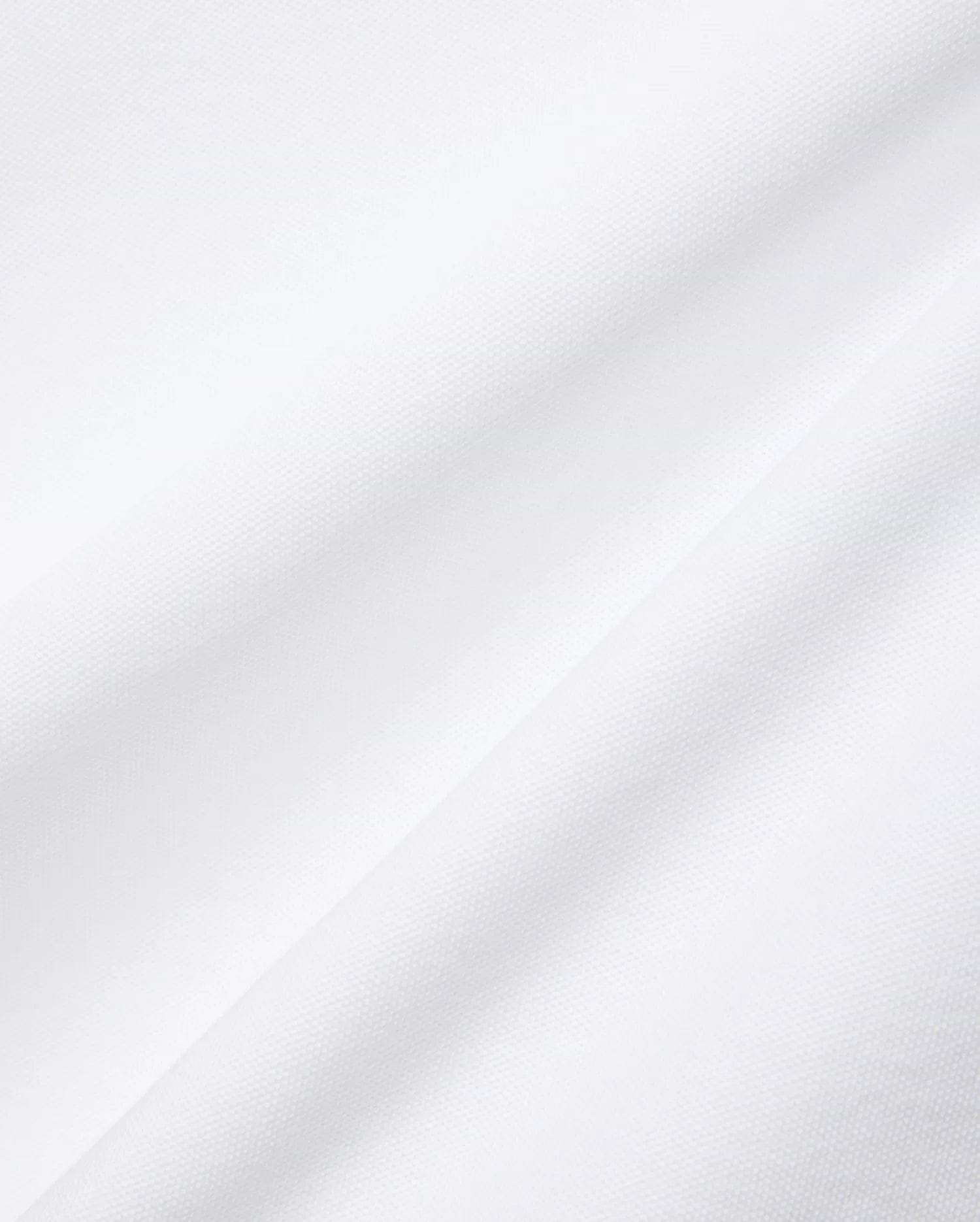 Mens Nate Pique Polo in crisp white, showcasing its premium, breathable, and finely textured pique fabric with subtle diagonal folds, embodying Psycho Bunny's refined streetwear aesthetic.