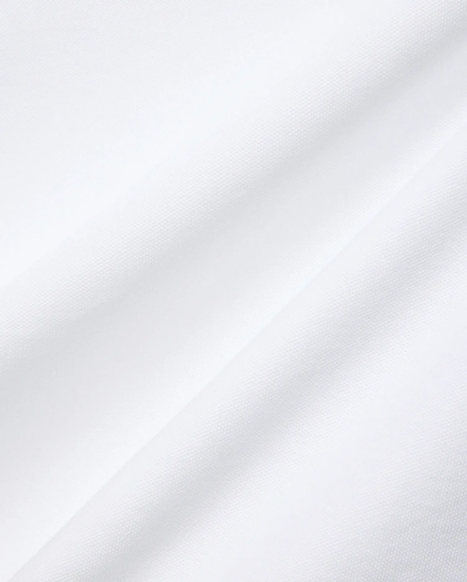 Mens Nate Pique Polo in crisp white, showcasing its premium, breathable, and finely textured pique fabric with subtle diagonal folds, embodying Psycho Bunny's refined streetwear aesthetic.