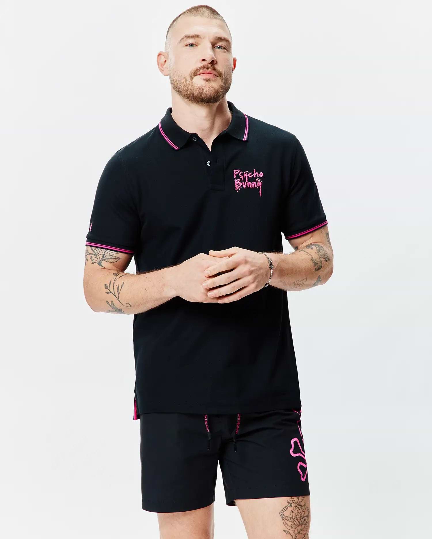 Mens Duncan Pique Polo, black with pink collar and cuff tipping. Features an embroidered pink Psycho Bunny chest logo, small sleeve bunny skull, and pink side vents. Classic fit.