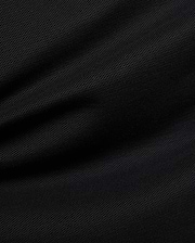 Premium black Mens Duncan Pique Polo, showcasing its breathable, classic pique fabric with a distinct textured weave and subtle folds, perfect for refined streetwear.