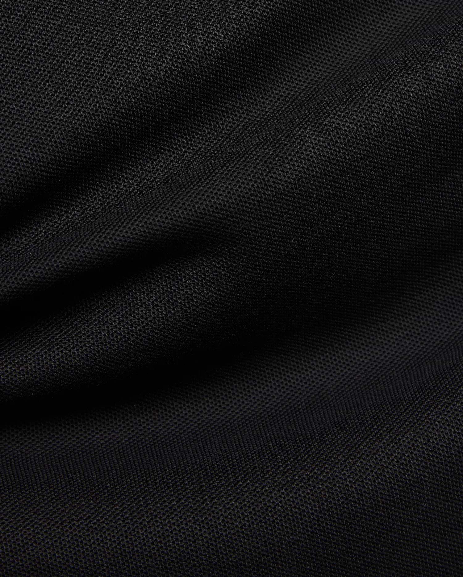Premium black Mens Duncan Pique Polo, showcasing its breathable, classic pique fabric with a distinct textured weave and subtle folds, perfect for refined streetwear.