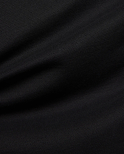Premium black Mens Duncan Pique Polo, showcasing its breathable, classic pique fabric with a distinct textured weave and subtle folds, perfect for refined streetwear.