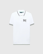 Mens Duncan Pique Polo, white classic fit pique polo with black striped collar and cuffs, featuring a distressed black Psycho Bunny text logo embroidered on the left chest and green neck tape.