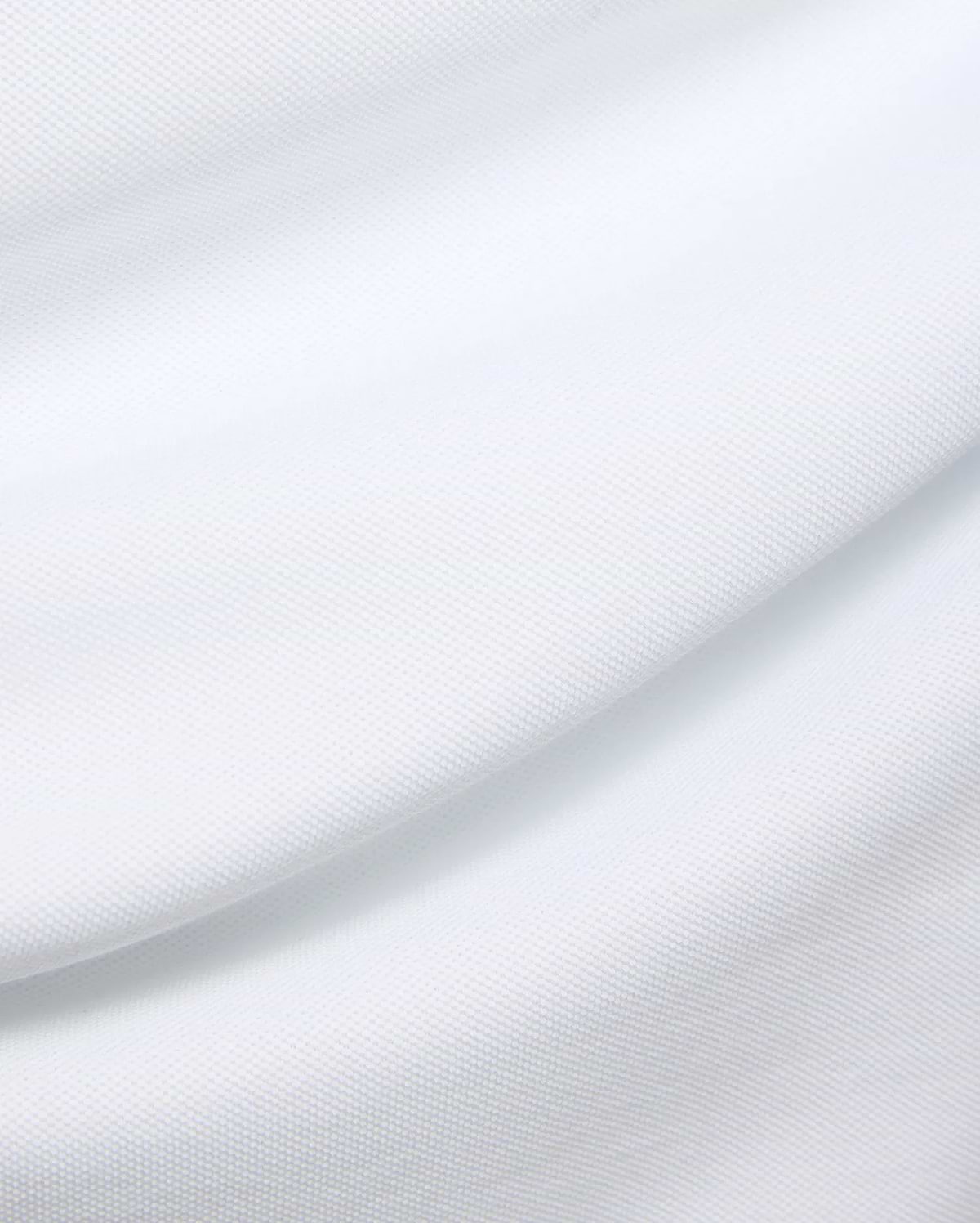 Mens Duncan Pique Polo in crisp white, a premium classic fit polo crafted from finely textured pique knit fabric, embodying Psycho Bunny's refined streetwear aesthetic.