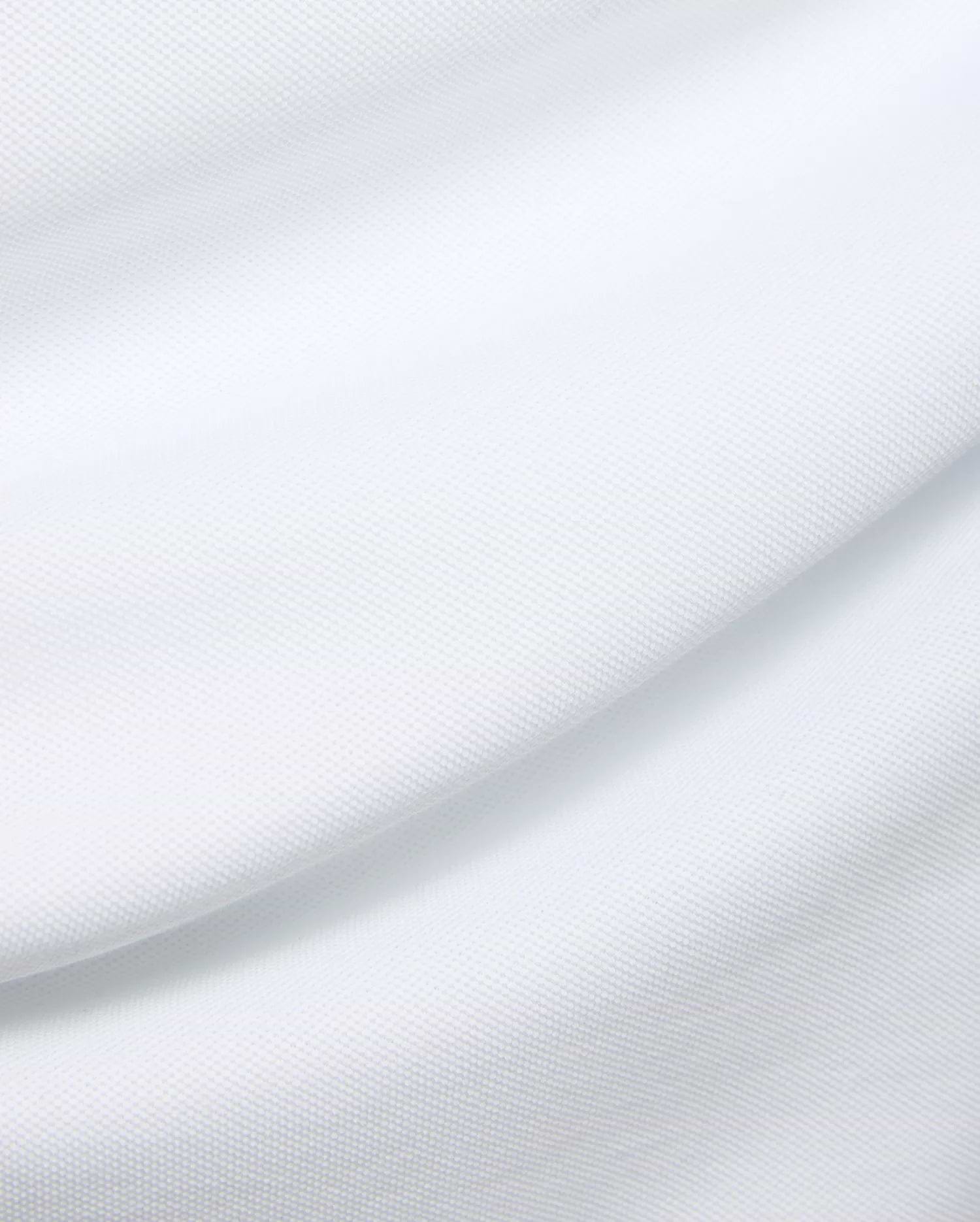 Mens Duncan Pique Polo in crisp white, a premium classic fit polo crafted from finely textured pique knit fabric, embodying Psycho Bunny's refined streetwear aesthetic.