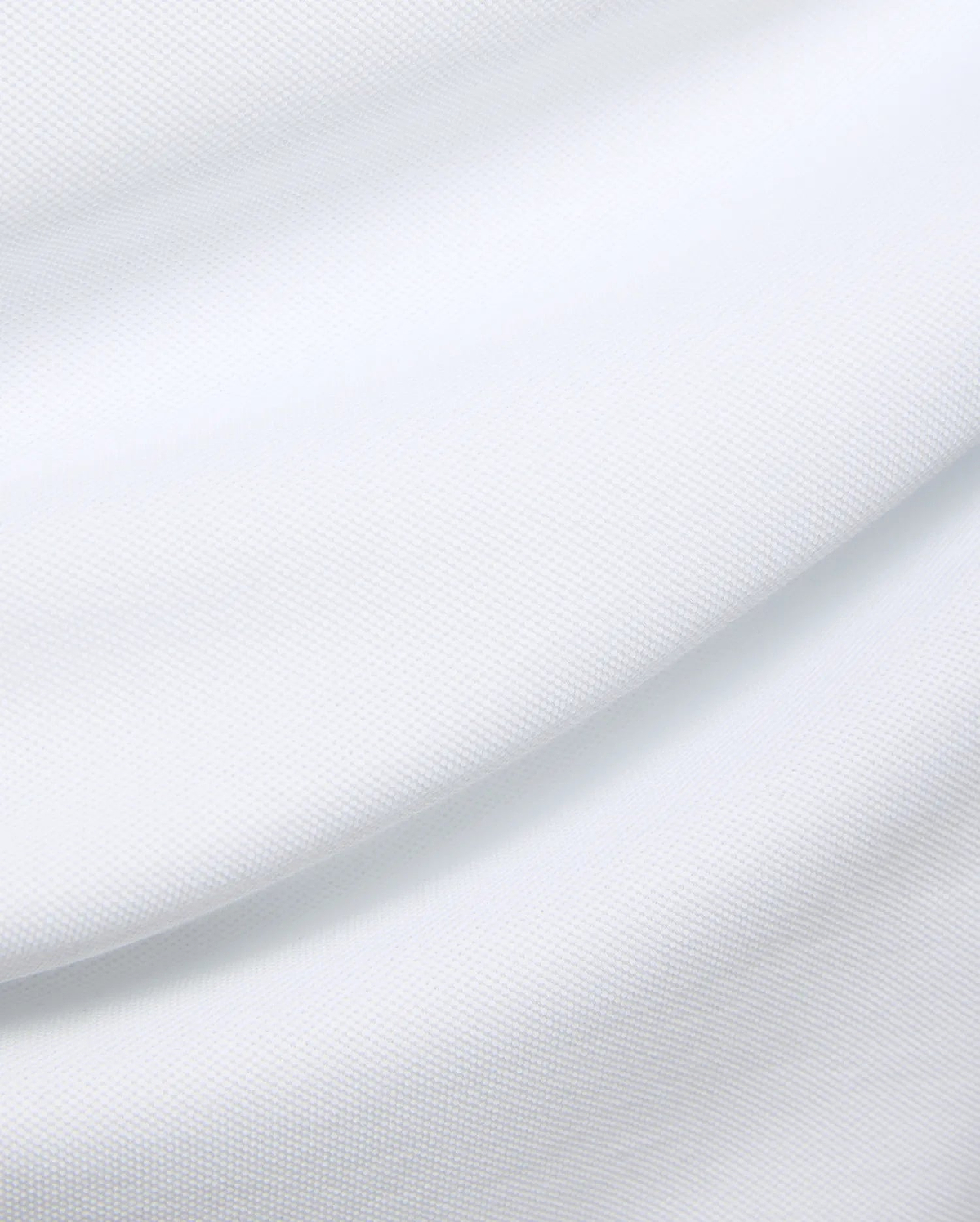 Mens Duncan Pique Polo in crisp white, a premium classic fit polo crafted from finely textured pique knit fabric, embodying Psycho Bunny's refined streetwear aesthetic.
