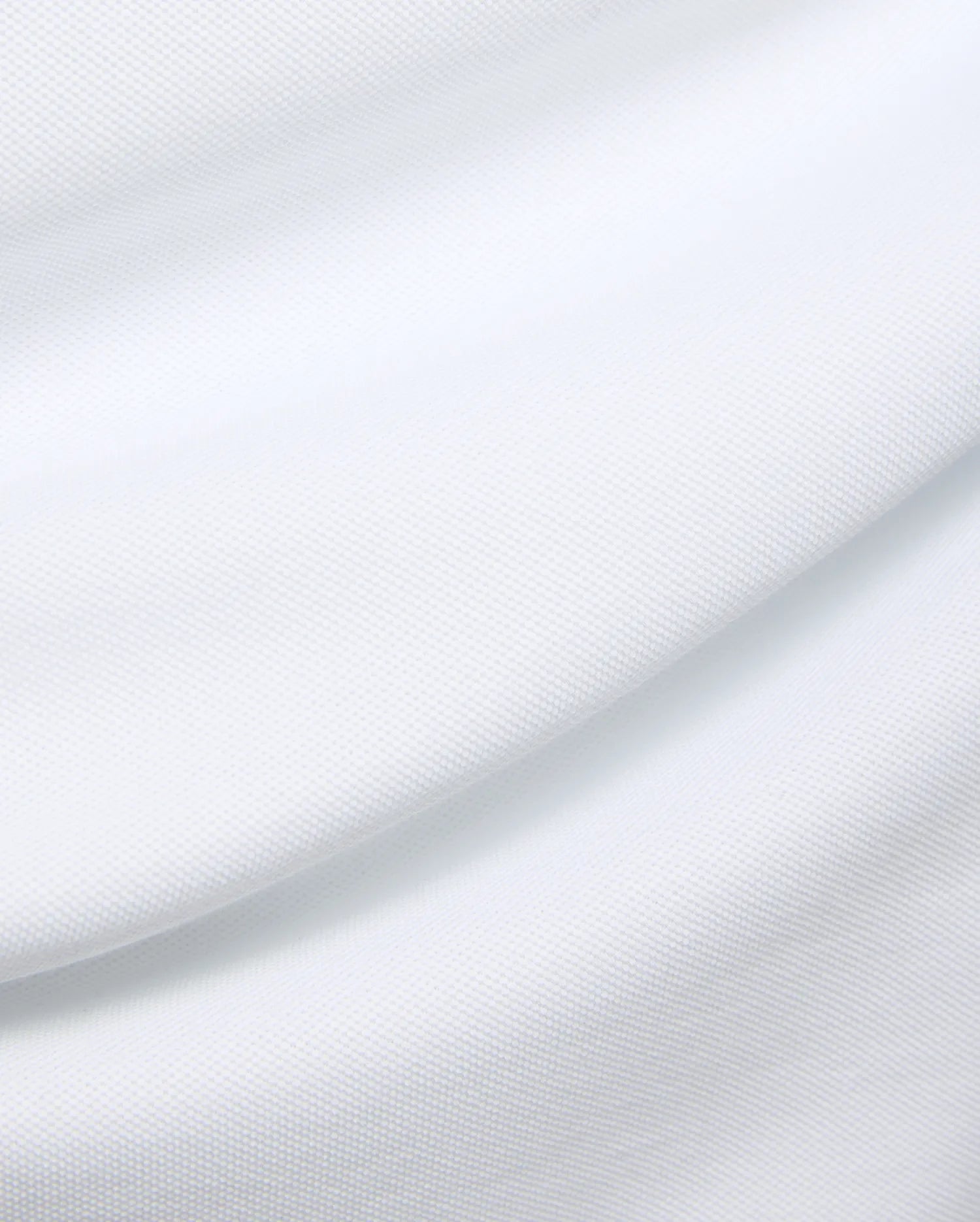 Mens Duncan Pique Polo in crisp white, a premium classic fit polo crafted from finely textured pique knit fabric, embodying Psycho Bunny's refined streetwear aesthetic.