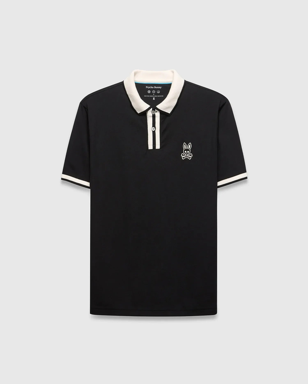 Mens Ridley Pique Polo, classic fit, black pique fabric with cream ribbed collar, two-button placket stripe, and cuff stripes. Features a white embroidered Psycho Bunny skull logo on the left chest. (4)
