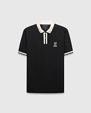 Mens Ridley Pique Polo, classic fit, black pique fabric with cream ribbed collar, two-button placket stripe, and cuff stripes. Features a white embroidered Psycho Bunny skull logo on the left chest. (4)