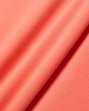 Close-up of the vibrant coral Mens Ridley Pique Polo fabric, featuring a distinct, premium textured pique knit, embodying Psycho Bunny's refined streetwear aesthetic. (7)