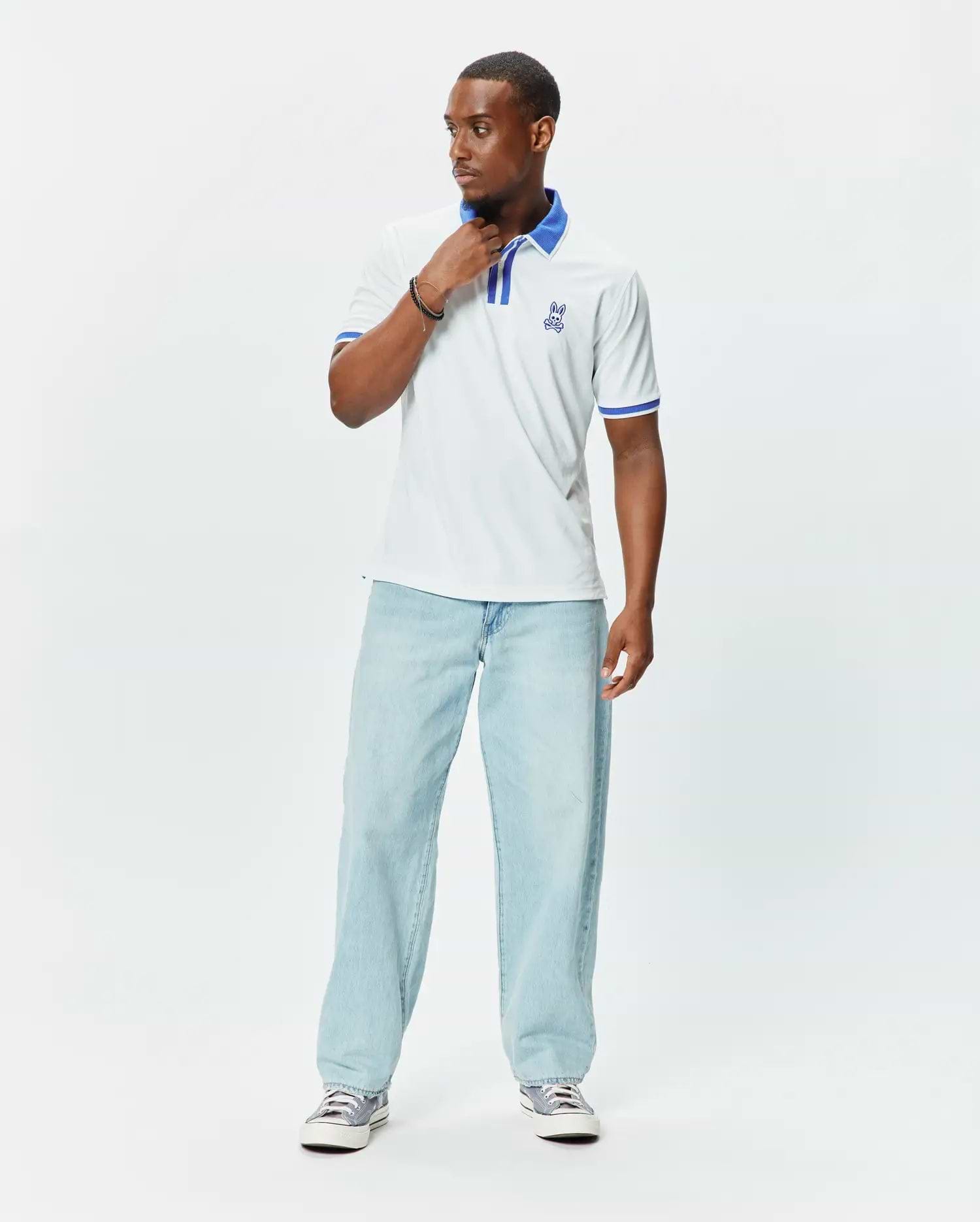 Mens Ridley Pique Polo in white pique, featuring a classic fit, blue striped collar and cuffs, and an embroidered blue Psycho Bunny skull logo on the left chest. (3)