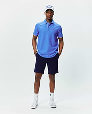 Mens Brad Pique Polo, vibrant blue classic fit pique polo with white tipping on collar and cuffs, featuring a small embroidered blue Psycho Bunny skull logo on the left chest.